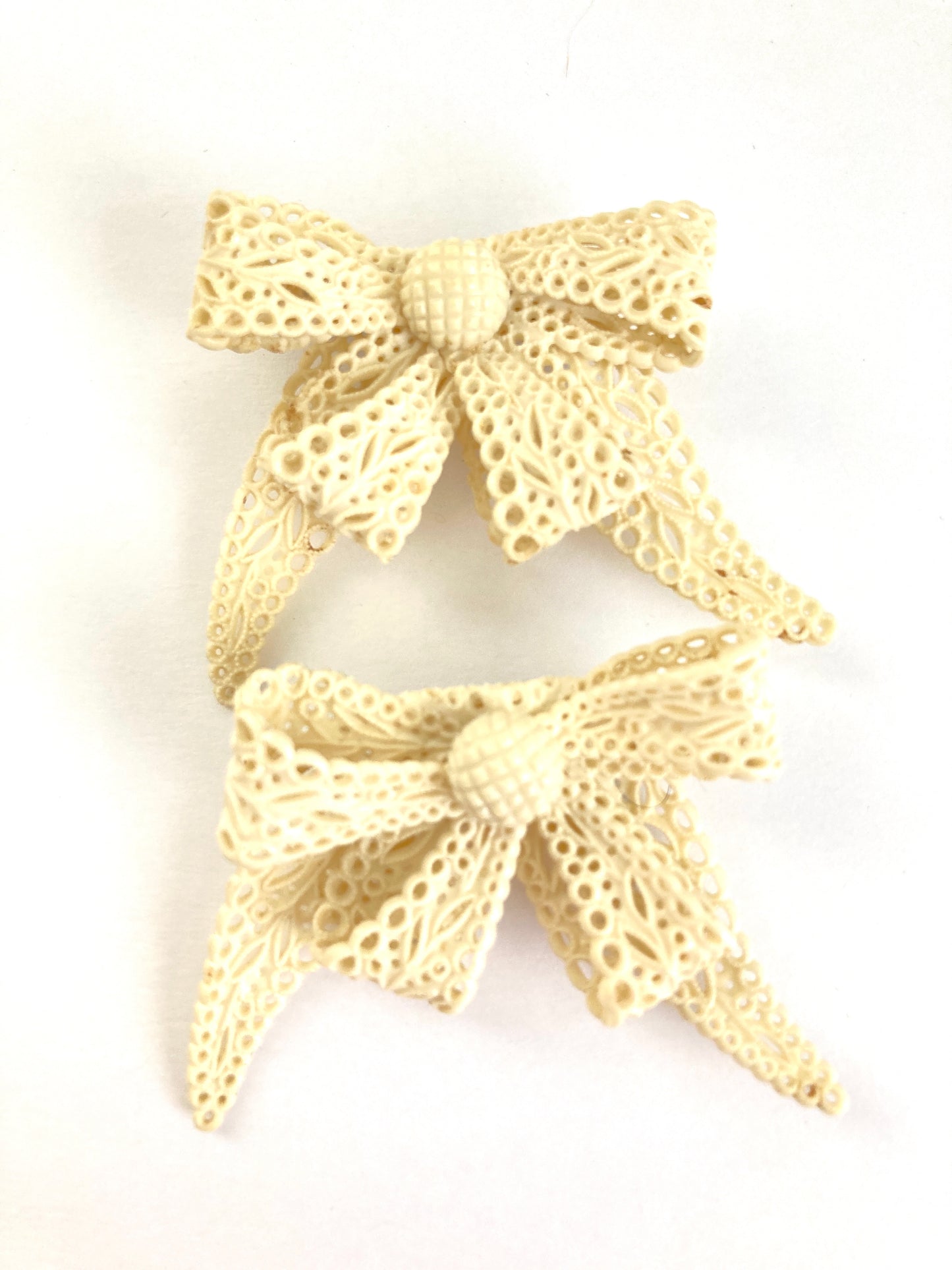 Pair of Celluloid Bow Brooches in Pierced Ivory