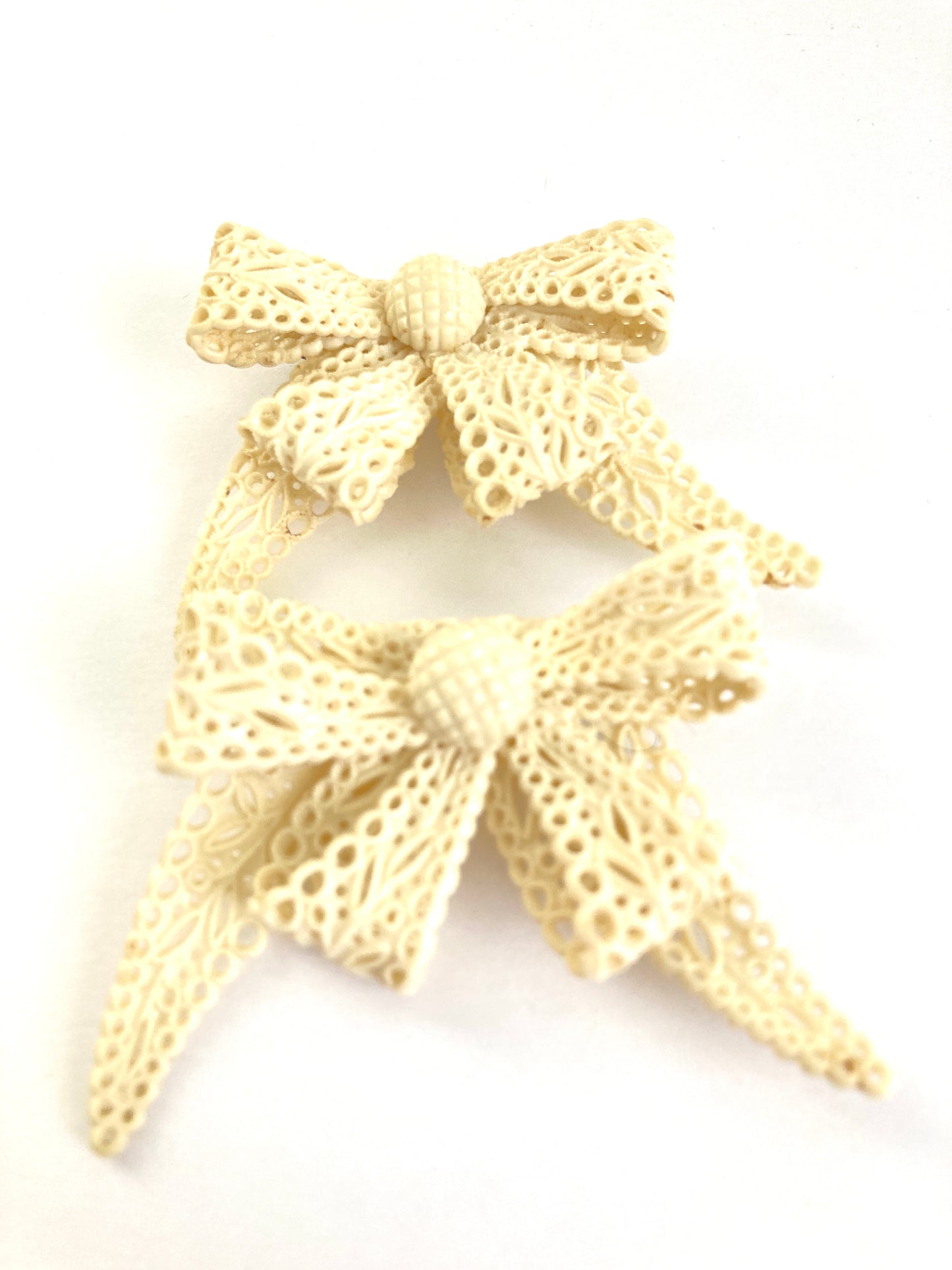 Pair of Celluloid Bow Brooches in Pierced Ivory