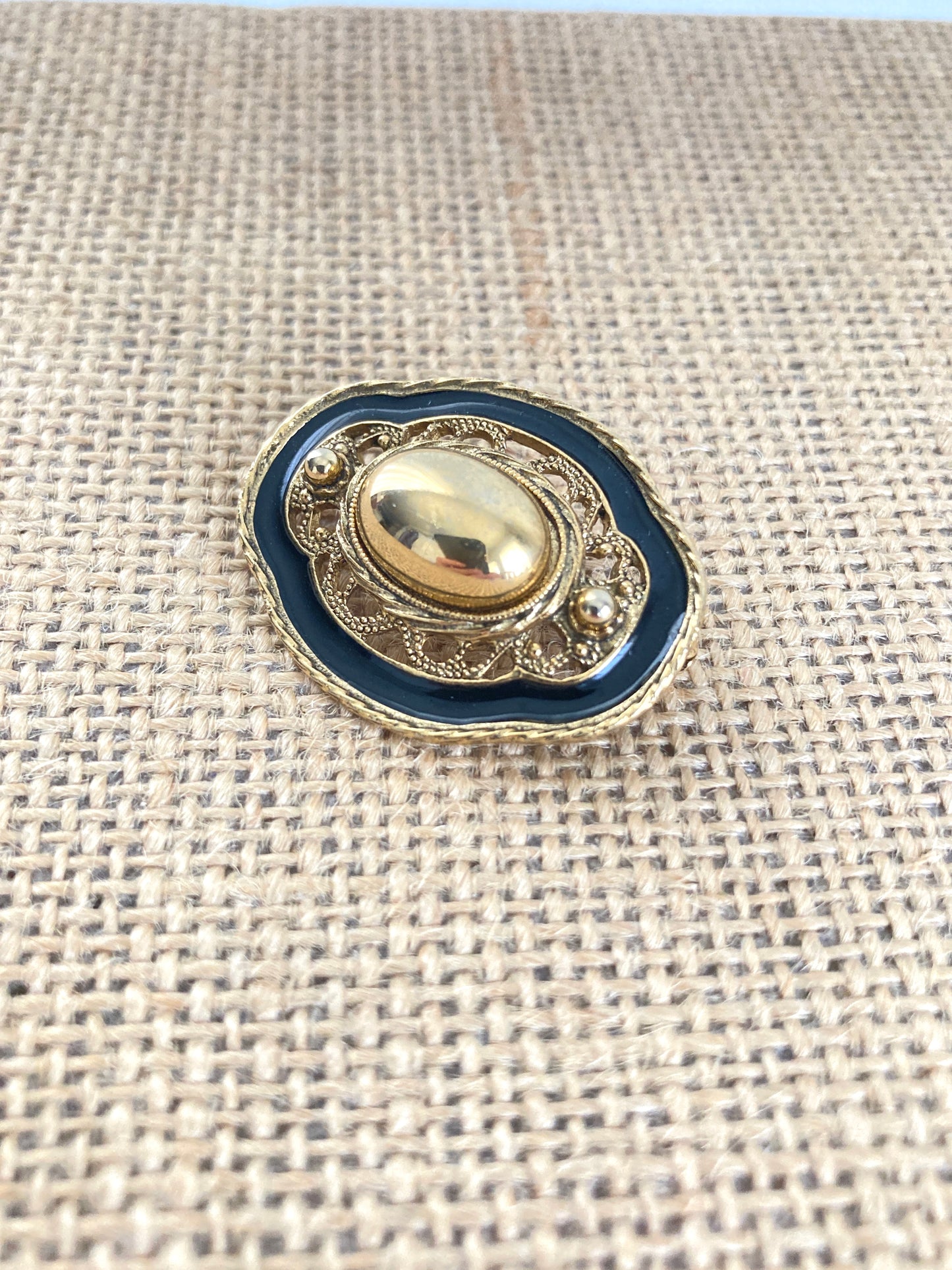 Oval Goldtone and Black Enamel Brooch