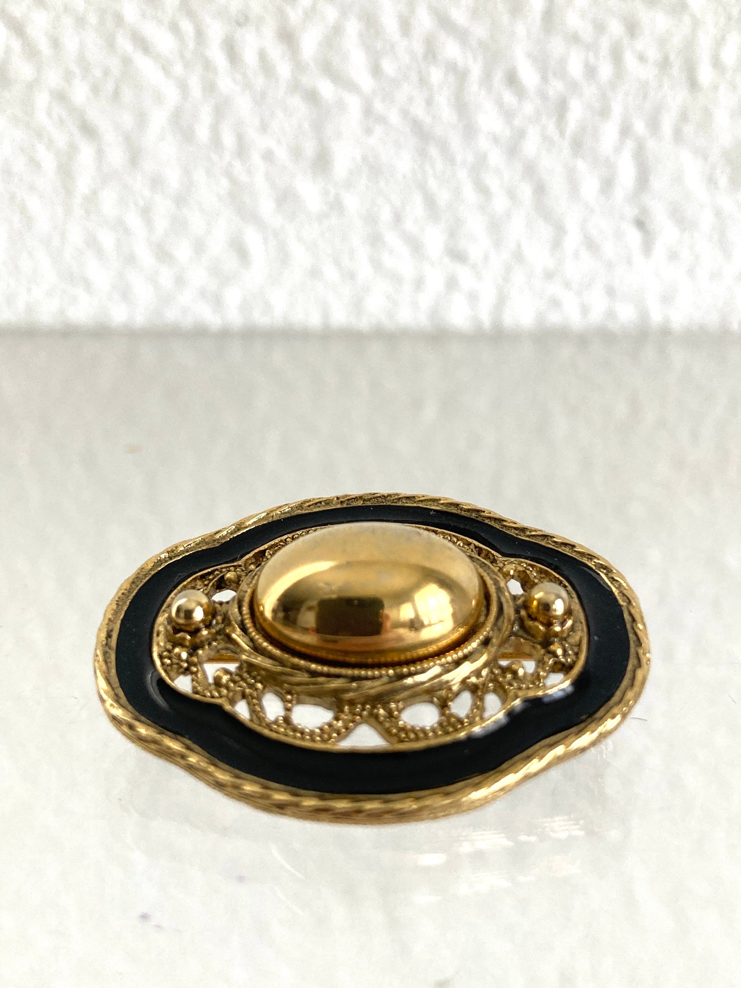 Oval Goldtone and Black Enamel Brooch